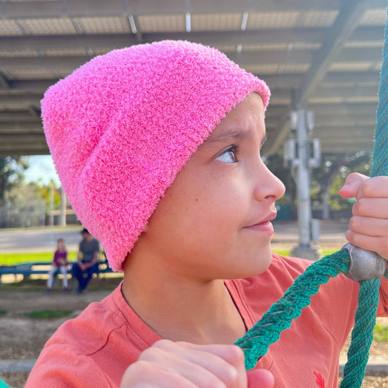 child wearing the pink beanie