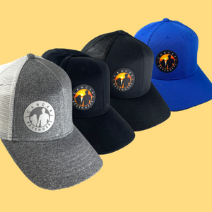 All four different types of hats compiled in one photo. The Baseball cap, trucker hat, jersey knit trucker hat and sustainable black baseball cap