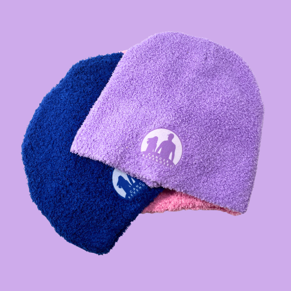  Pink, blue and purple beanies stacked together