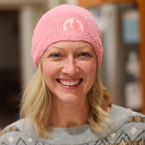 Adult wearing the pink beanie