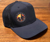 black sustainable trucker hat with colored sunset logo on a table